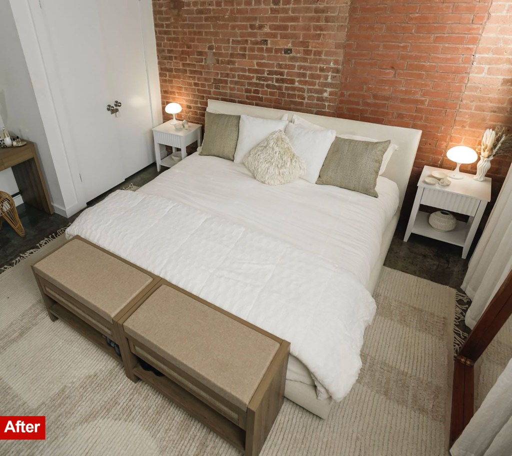 Makeover from the bedroom Then: A white bed with beige pillows sits on a rug in front of a brick wall. Two coincided benches are at the foot of the bed.